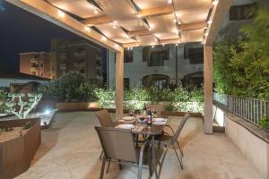 a patio with a table and chairs on a balcony at Colino APT in Olbia