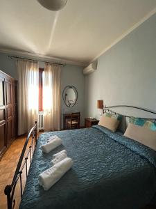 a bedroom with a large bed with two towels on it at Agriturismo La Valle dei Conti in Cesena