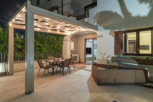 a patio with a table and chairs on a balcony at Colino APT in Olbia