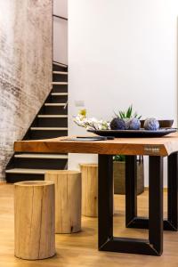 a wooden table with a plate of fruit on it at Mercatovecchio Luxury Suites in Udine