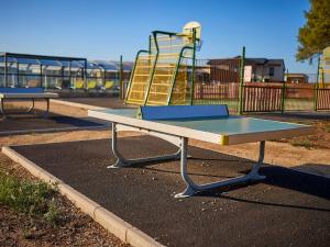 a picnic table in a park with a playground at Chalet 3 chb, 2 sde, domaine sécurisé avec piscine chauffée, proche plages Méditerranée - FR-1-783-22 in Pomérols