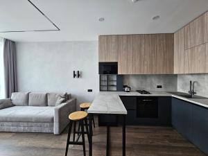 a kitchen and living room with a couch and a table at Apartment 98 at Park Residence in Lviv