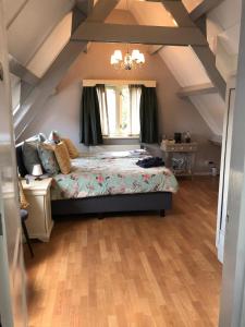 a bedroom with a large bed in a attic at Bed en Breakfast 1394 in Nederhorst den Berg +32 photos