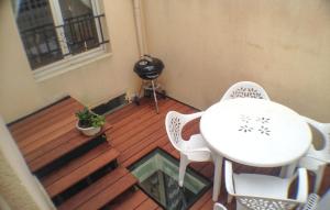 a balcony with a white table and chairs and a window at Lovely Home In Deauville With Wifi in Deauville