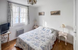 a bedroom with a bed and a tv and a window at Lovely Home In Deauville With Wifi in Deauville +15 photos