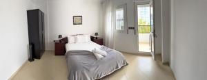 a bedroom with a bed with white sheets and pillows at la perle de tanger in Tangier