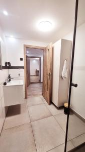 a kitchen with a sink and a refrigerator at Lindenhaus in Sibiu +84 photos