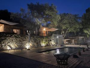a swimming pool in front of a house at night at Bastide de Charme en Pierre avec Piscine dans le Golfe de Saint Tropez in Plan-de-la-Tour