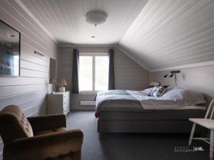 una camera da letto con un letto, una sedia e una finestra di Hus nær butikk, sentrum & rekreasjon a Hol Altre 2 foto