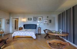 a bedroom with a bed and a table at Gorgeous Home In Porto San Giorgio in Porto San Giorgio