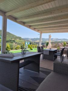 a patio with a table and chairs with a view at Villa Criade in Castelsardo