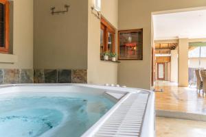 a large jacuzzi tub in a house at Zebula Golf Estate & Spa Executive Holiday Homes in Mabula