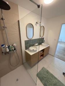 a bathroom with a shower and a sink and a mirror at Casa Côme - Maison climatisée - Tout à pied ! in Saint-Vincent-sur-Jard +38 photos