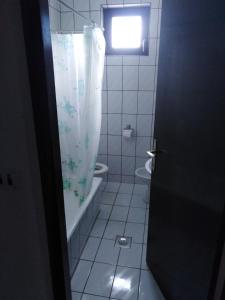 a bathroom with a tub and a shower curtain at Villa Milas - Apartman 01 in Tkon