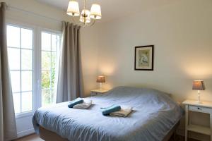 a bedroom with a bed with two pillows on it at Moulin de Vigne in Corgnac-sur-lʼIsle