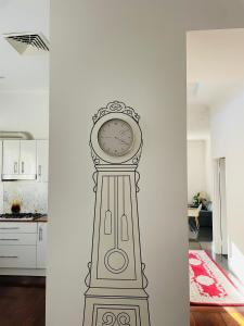 a clock mural on a wall in a room at Cozy and Peaceful home surrounding by cafes and restaurants in Perth