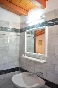 a bathroom with a sink and a mirror at Villa Maraki in Agia Paraskevi