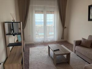 a living room with a couch and a coffee table at SMYRNA HOMES ASTRONOMi in Chios