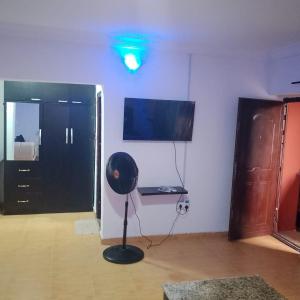 a room with a fan in the middle of a room at Peace in Lekki