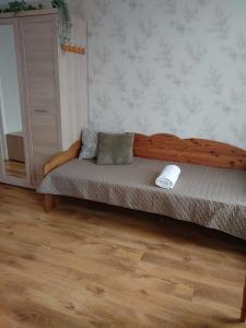 a bed with two pillows on it in a room at Dzīvoklis Vecliepājā in Liepāja