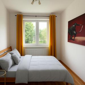 a bedroom with a bed and a window at 3BR near Center with Parking in Bratislava