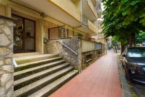 a building with stairs and a car parked on a sidewalk at Casa Nonna Adri in Levanto