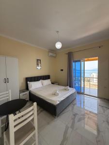 a bedroom with a bed and a view of the ocean at Villa Evelyn Free Parking in Vlorë