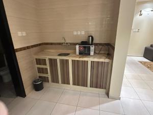 a small kitchen with a microwave on a counter at كيان الين للشقق المخدومة -حياة ايليت سابقا in Abha