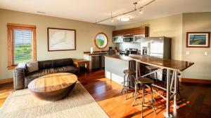 a kitchen and living room with a couch and a table at Kite Point - Waterfront 2-Bedroom, 2-Bathroom Suite at REAL Watersports in Waves