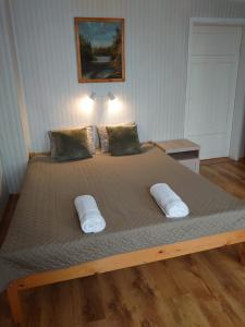 a bedroom with a large bed with two pillows at Dzīvoklis Vecliepājā in Liepāja