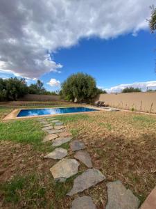 a swimming pool in the middle of a field at Villa cherif in Chouiter
