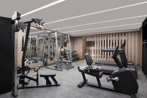 a gym with several treadmills and exercise bikes at Crowne Plaza Lucknow by IHG in Lucknow