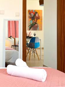 a view of a bedroom with a bed and a mirror at Sunset Balcony and Espresso Station Apartment in Larnaka +28 photos