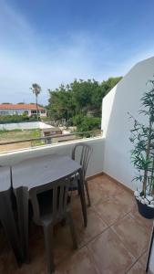 a table and chairs on a balcony with a plant at Résidence San Paolisa in Hyères