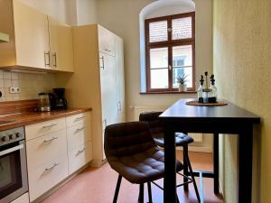 a kitchen with a table with two chairs and a window at Gassentraum NEU mit Balkon in Pirna