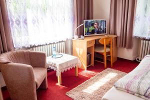 a room with a desk with a computer and a chair at Wohlfühlhotel Saxonia in Bad Kissingen