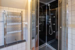 a shower with a glass door in a bathroom at Maison Salle de Musique in La Forge-dʼAns +12 photos
