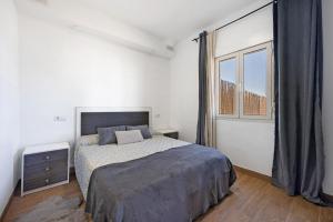 a bedroom with a bed and a large window at Villa Manoli in Chiclana de la Frontera +18 photos