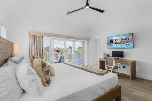 a bedroom with a bed and a desk and a window at Prime Location, Heated Pool, Game Room - FMB- Beach Please - Roelens in Fort Myers Beach