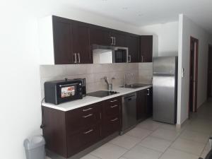 Η κουζίνα ή μικρή κουζίνα στο Briloc Appartements Pietrosella à 50m de la plage