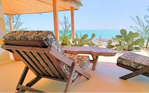 a patio with a table and a chair and a table at Savannah Beach in Ambatomilo