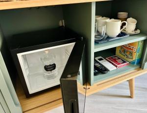 a bottle of water is inside of an open refrigerator at Salty Suite in Levanto