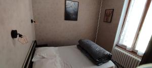 a bedroom with a bed with a pillow on it at Villa Mon Repos 3 in La Bourboule