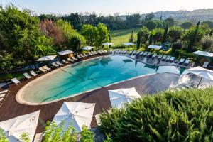 an overhead view of a pool with chairs and umbrellas at A.Roma Lifestyle Hotel in Rome