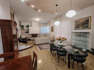 a living room with a table and chairs and a couch at Villa Andreina in Amandola