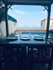 a table with plates and glasses on top of it at Dahab Panorama Villa Private Pool in Dahab
