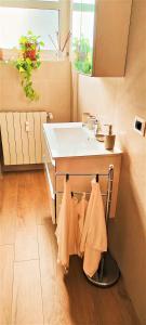 a bathroom with a sink and towels on a counter at Andrea e Sofia Rho Fiera Milano in Rho