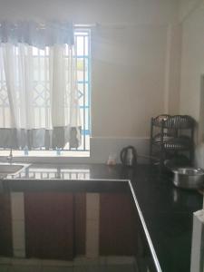 a kitchen with a counter top and a window at Miles haven in Kakamega