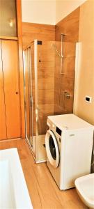 a bathroom with a shower and a washing machine at Andrea e Sofia Rho Fiera Milano in Rho +17 photos
