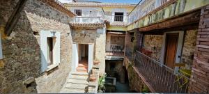 an alley in an old building with stairs and balconies at Palazzo Cafarelli in Laureana Cilento